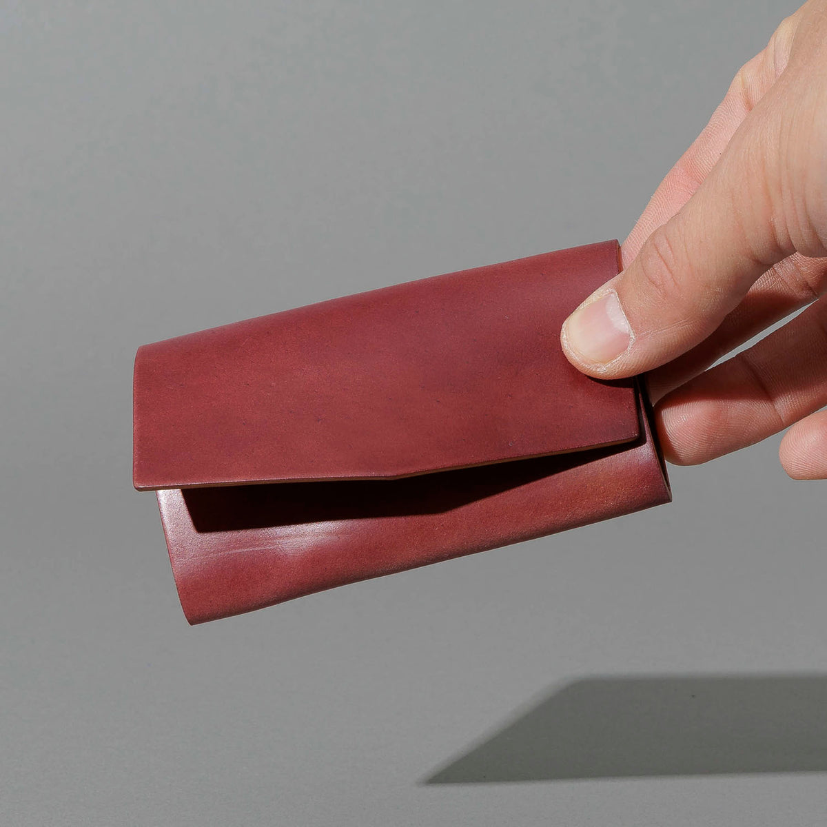 One-Off Jr. Fold in Marbled Ultraviolet Shell Cordovan, held in hand, shot 1