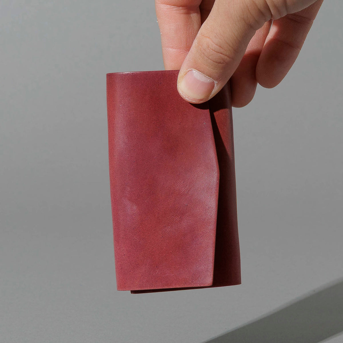 One-Off Jr. Fold in Marbled Ultraviolet Shell Cordovan, held in hand, shot 2