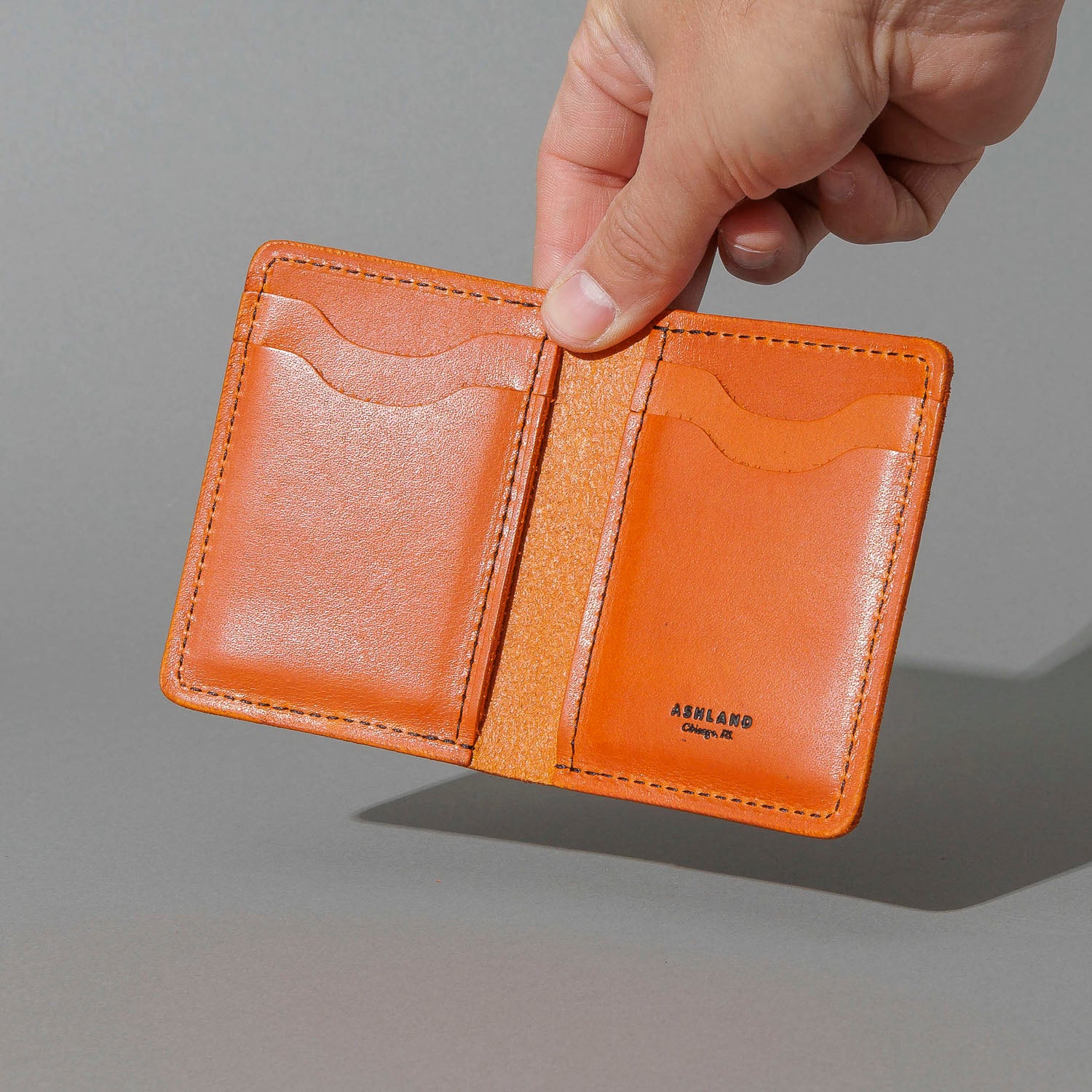 Vertical Bugs Moran in Orange Latigo, held open in hand, shot 1