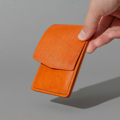 One-Off Lucky Wallet in Epic Orange Latigo, held in hand, shot 1