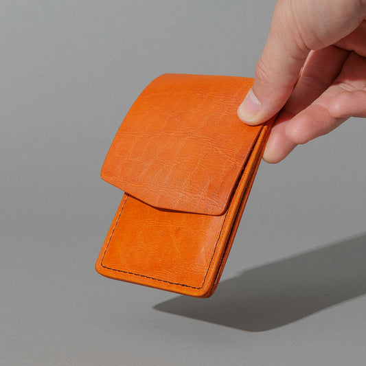 One-Off Lucky Wallet in Epic Orange Latigo, held in hand, shot 1