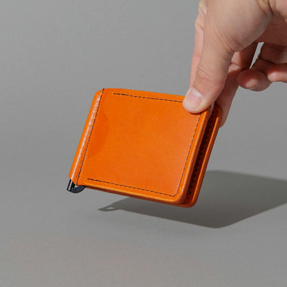 Capone Money Clip in Orange Latigo, held in hand, shot 1