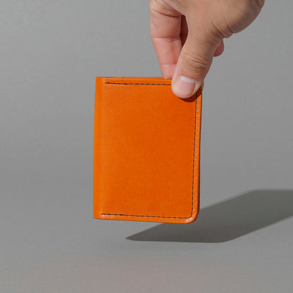 One-Off Six-Slot Bugs Moran Prototype in Orange Latigo, No Skip Stitch, held in hand, shot 1