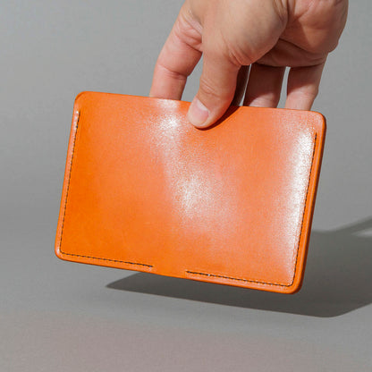 One-Off Six-Slot Bugs Moran Prototype in Orange Latigo, Skip Stitch, held in hand