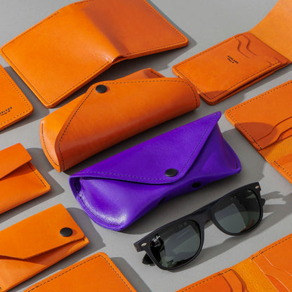 Glasses Case in Orange Latigo, group shot with other Fall Limited Release pieces