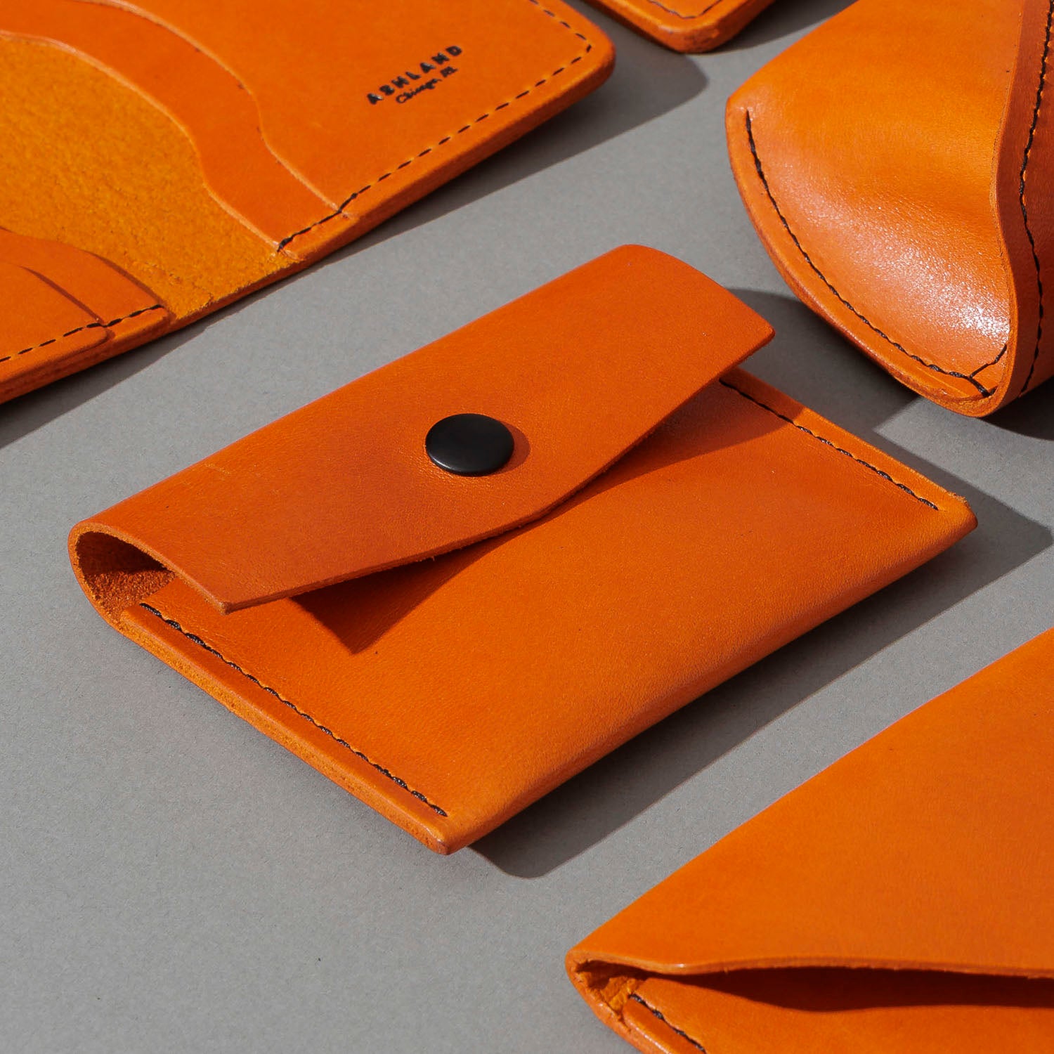 Vic Snap Wallet in Orange Latigo, group shot with other Fall Limited Release pieces