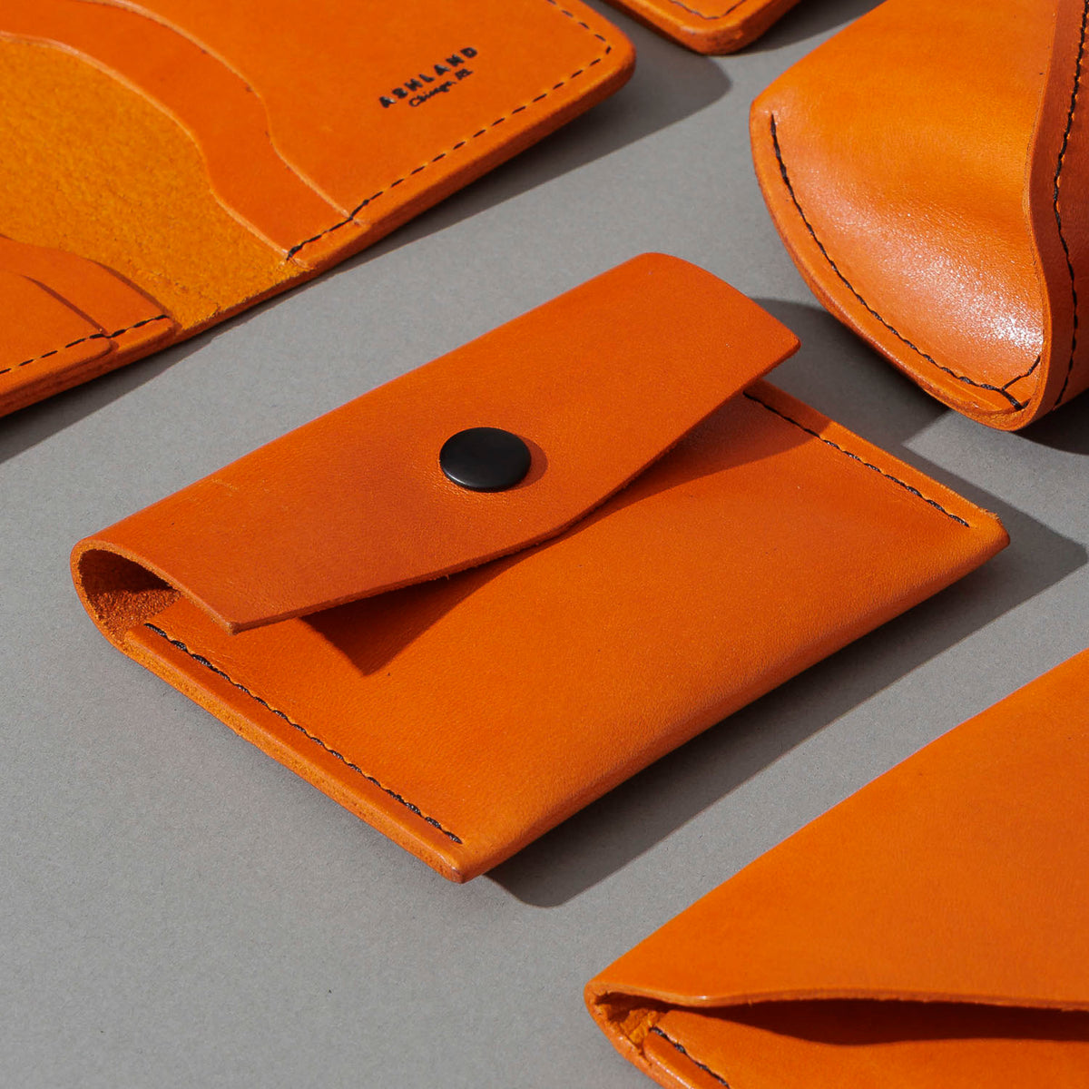 Vic Snap Wallet in Orange Latigo, group shot with other Fall Limited Release pieces