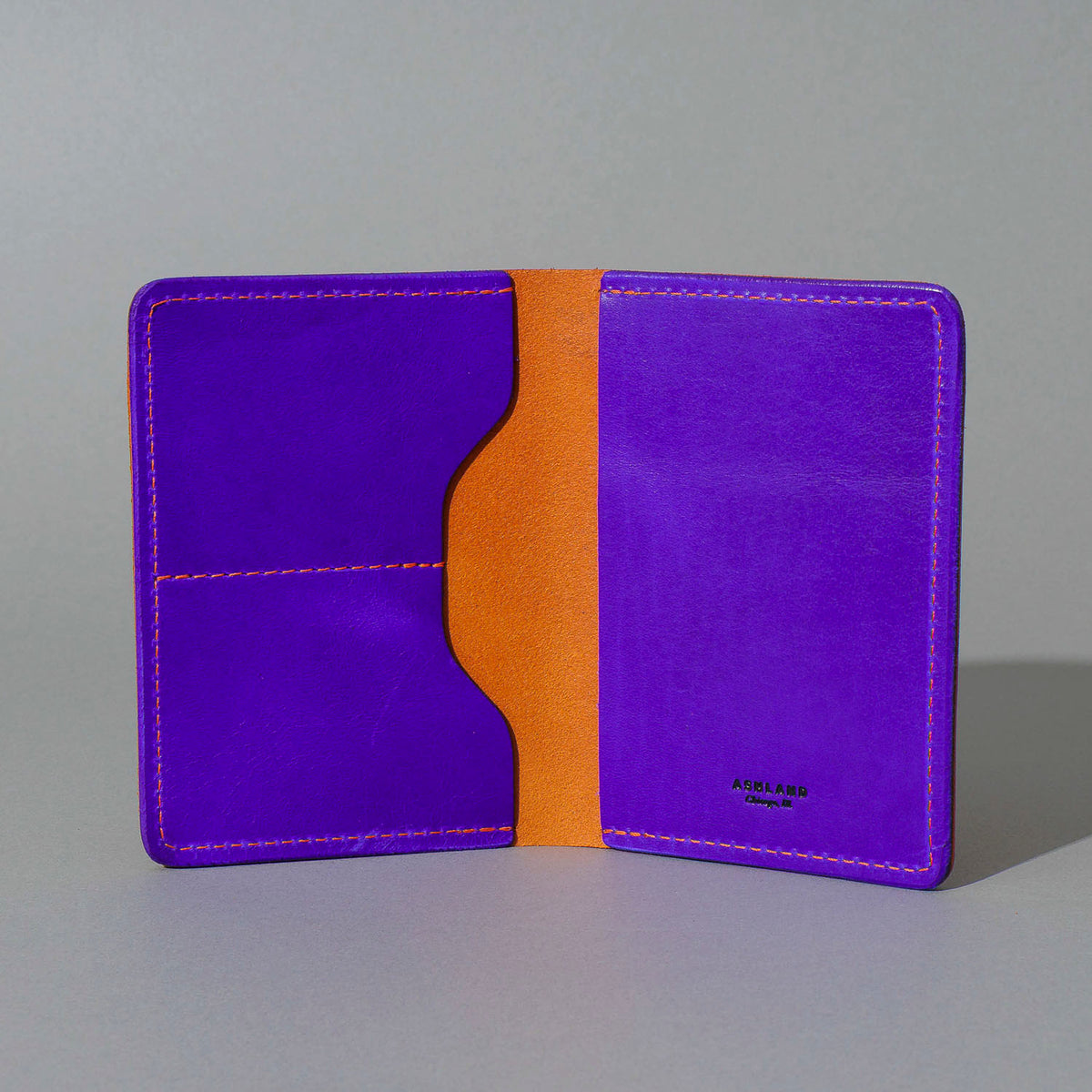 Traveler Passport Holder in Orange Latigo Exterior, Violet Latigo Interior, open, showing interior