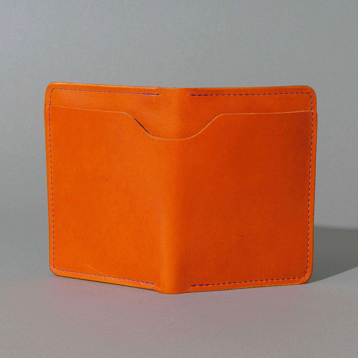 Traveler Passport Holder in Orange Latigo Exterior, Violet Latigo Interior, front view