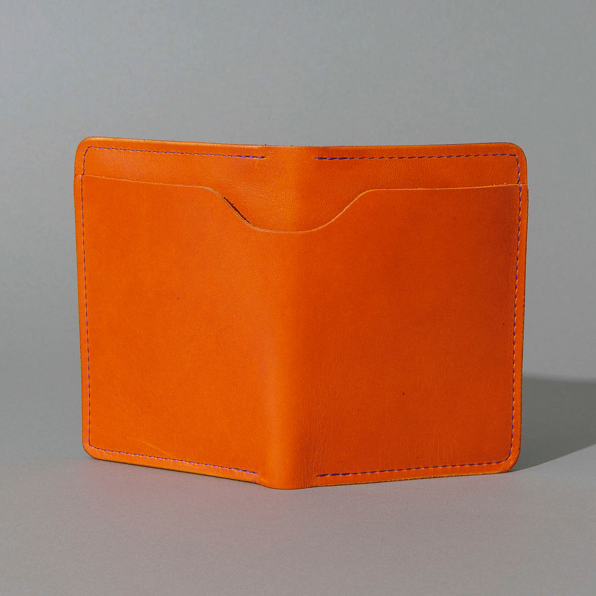 Traveler Passport Holder in Orange Latigo Exterior, Violet Latigo Interior, front view