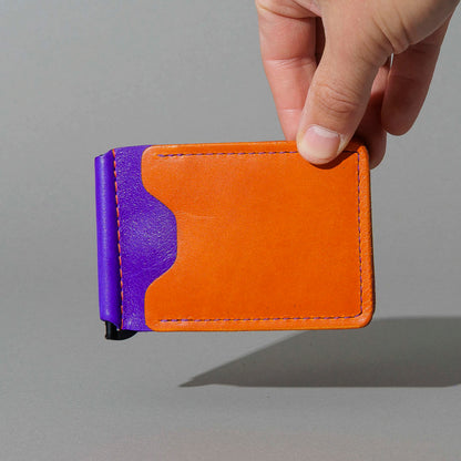 One-Off Capone Money Clip in Orange on Violet Latigo, held in hand, shot 1