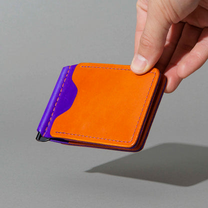 One-Off Capone Money Clip in Orange on Violet Latigo, held in hand, shot 2