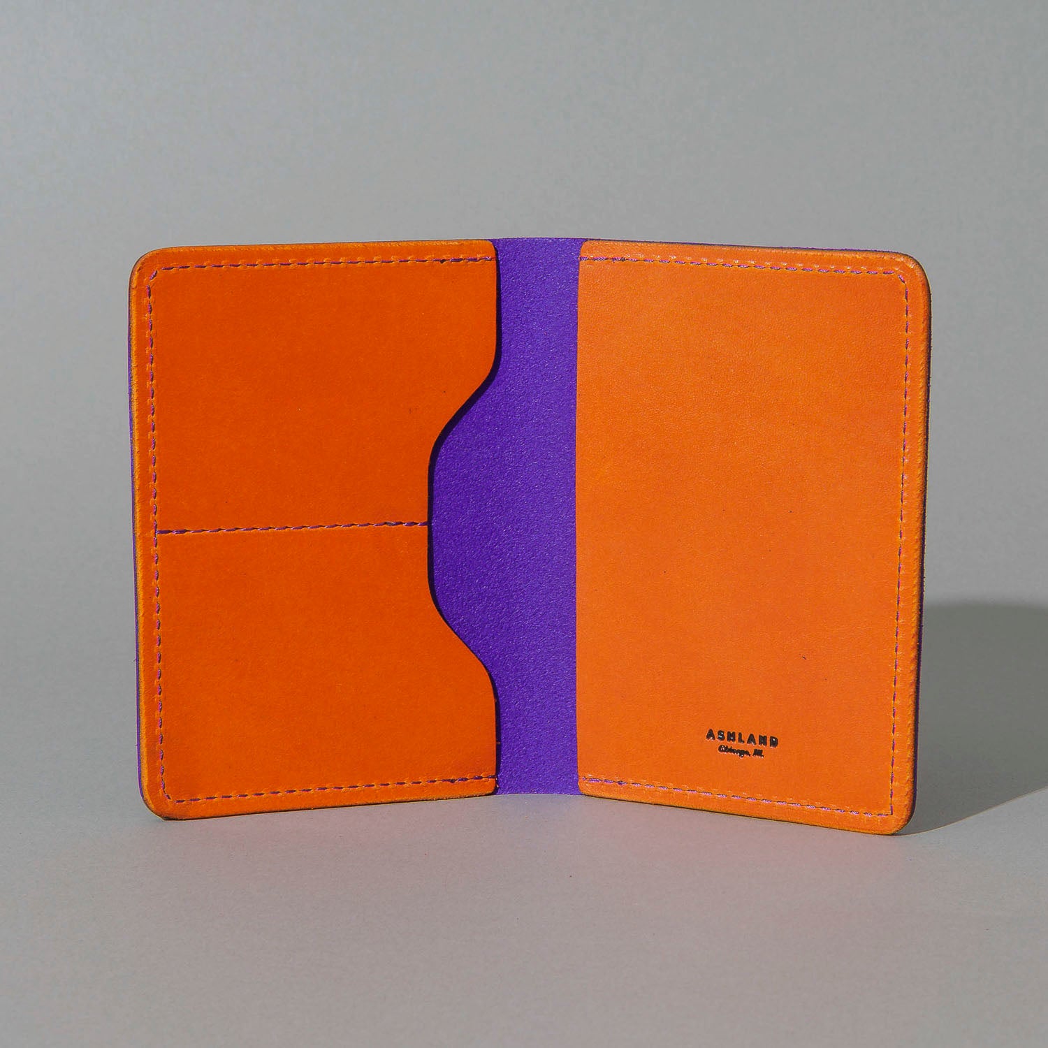 Traveler Passport Holder in Violet Latigo Exterior, Orange Latigo Interior, open, showing interior