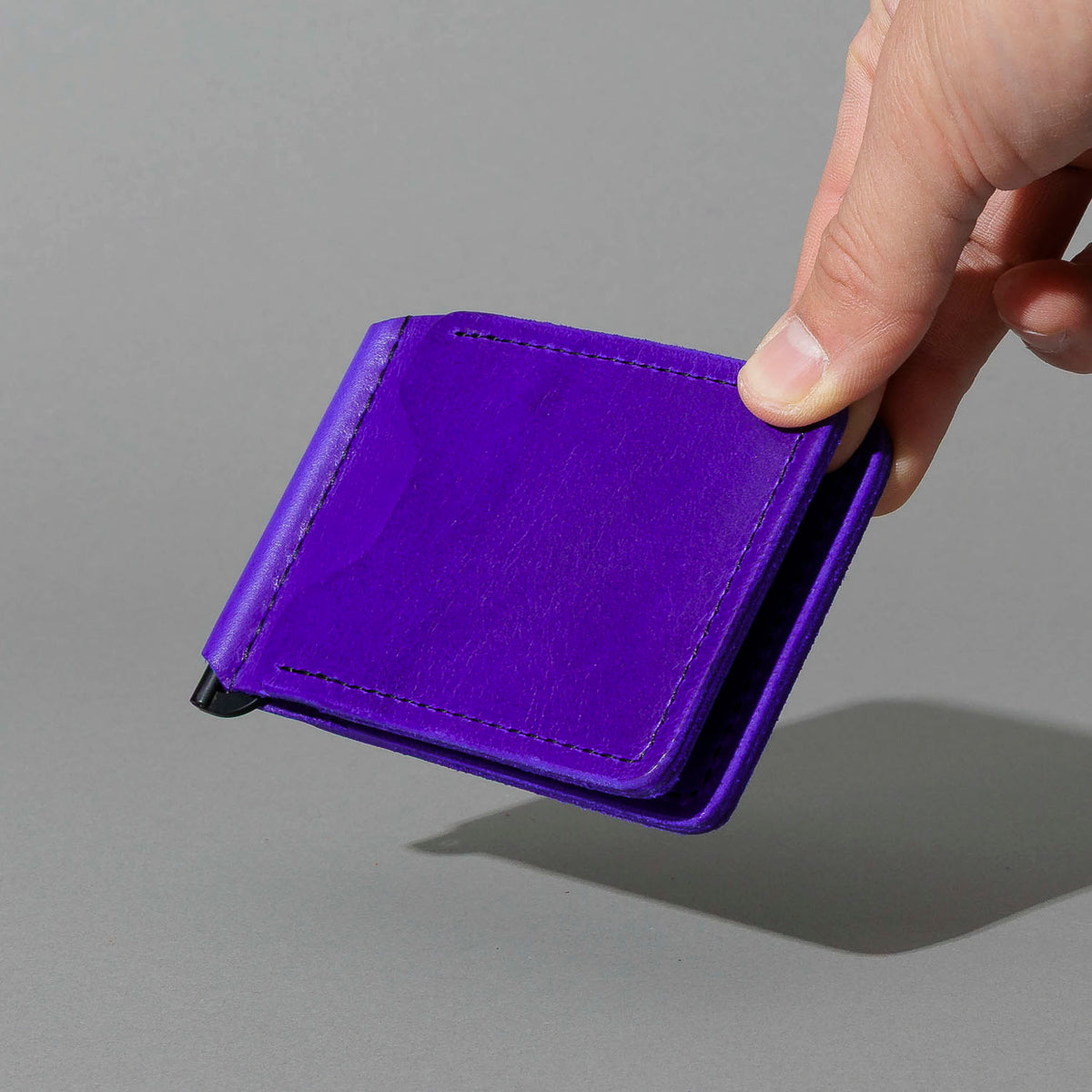 Capone Money Clip in Violet Latigo, held in hand, shot 4