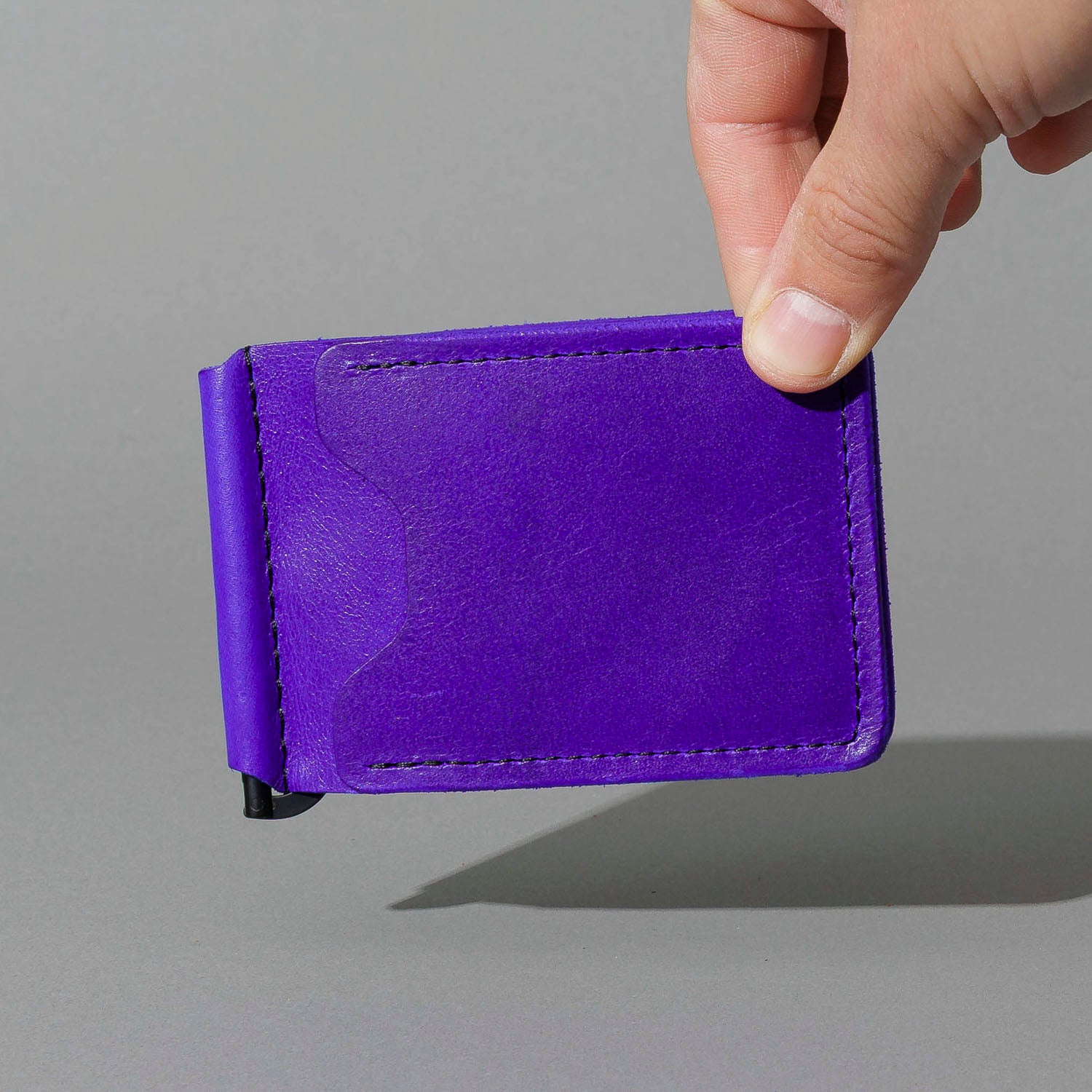 Capone Money Clip in Violet Latigo, held in hand, shot 1