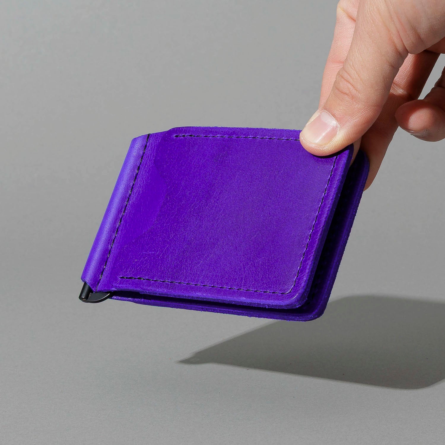 Capone Money Clip in Violet Latigo, held in hand, shot 2