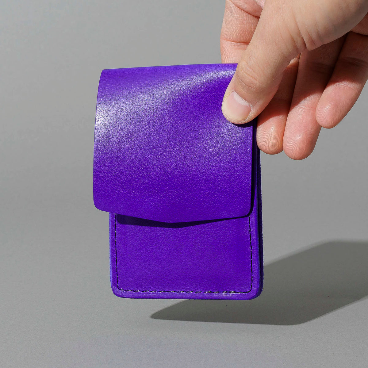 Lucky Wallet in Violet Latigo, held in hand, shot 2