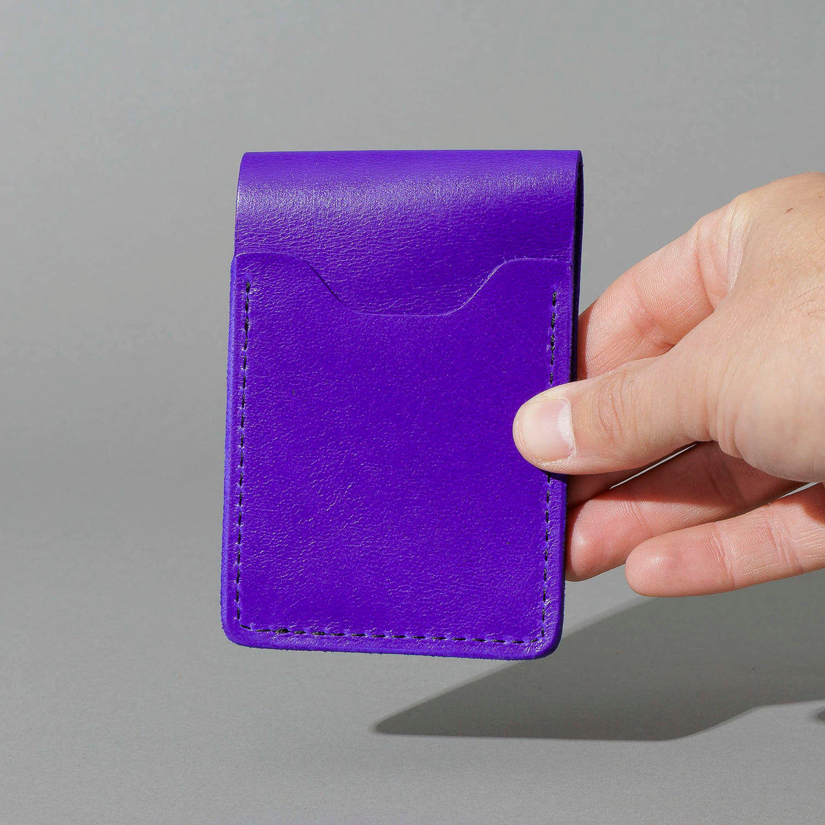 Lucky Wallet in Violet Latigo, held in hand, shot 4