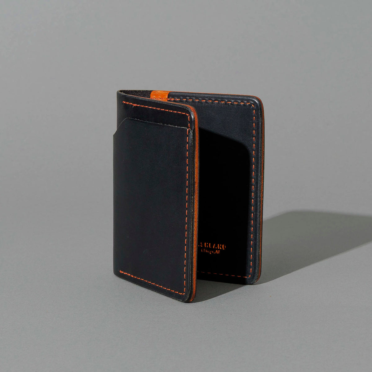 Tony the Ant in Black Dublin with Orange Accents, standing upright, side angle