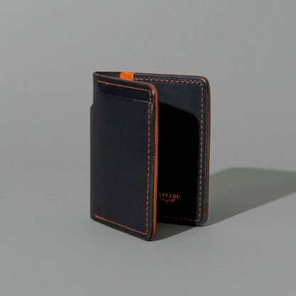 Tony the Ant in Black Dublin with Orange Accents, standing upright, side angle
