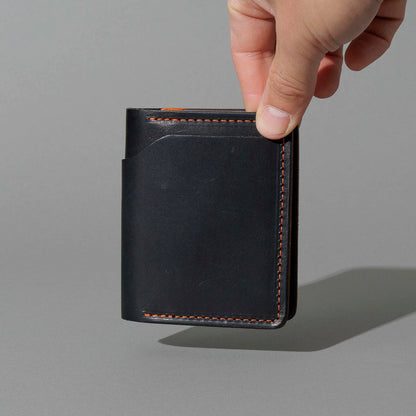 Tony the Ant in Black Dublin with Orange Accents, held in hand