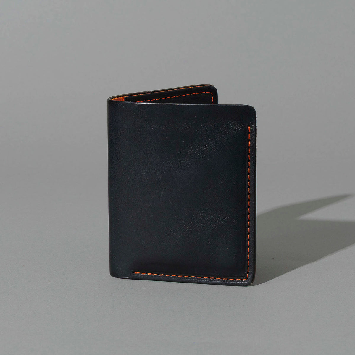 Tall Vertical Tony in Black Dublin with Orange Accents, standing upright, side angle, shot 1