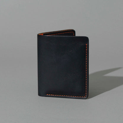 Tall Vertical Tony in Black Dublin with Orange Accents, standing upright, side angle, shot 1
