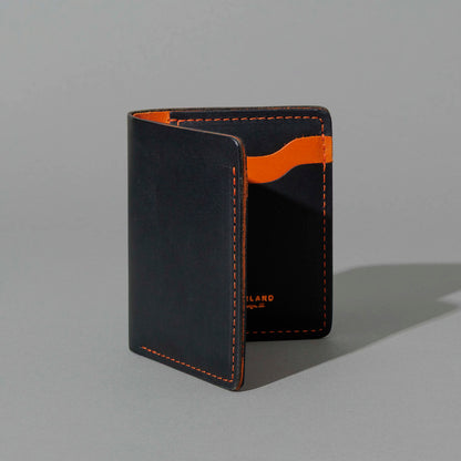 Tall Vertical Tony in Black Dublin with Orange Accents, standing upright, side angle, shot 2