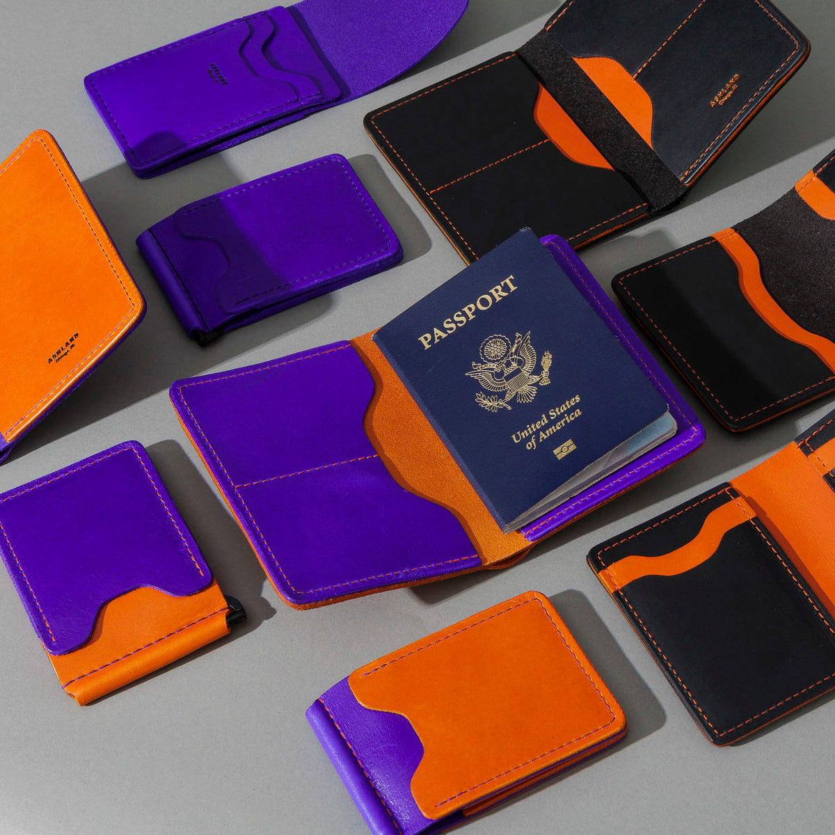 Traveler Passport Holder in Orange Latigo Exterior, Violet Latigo Interior, group shot with other Fall Limited Release pieces