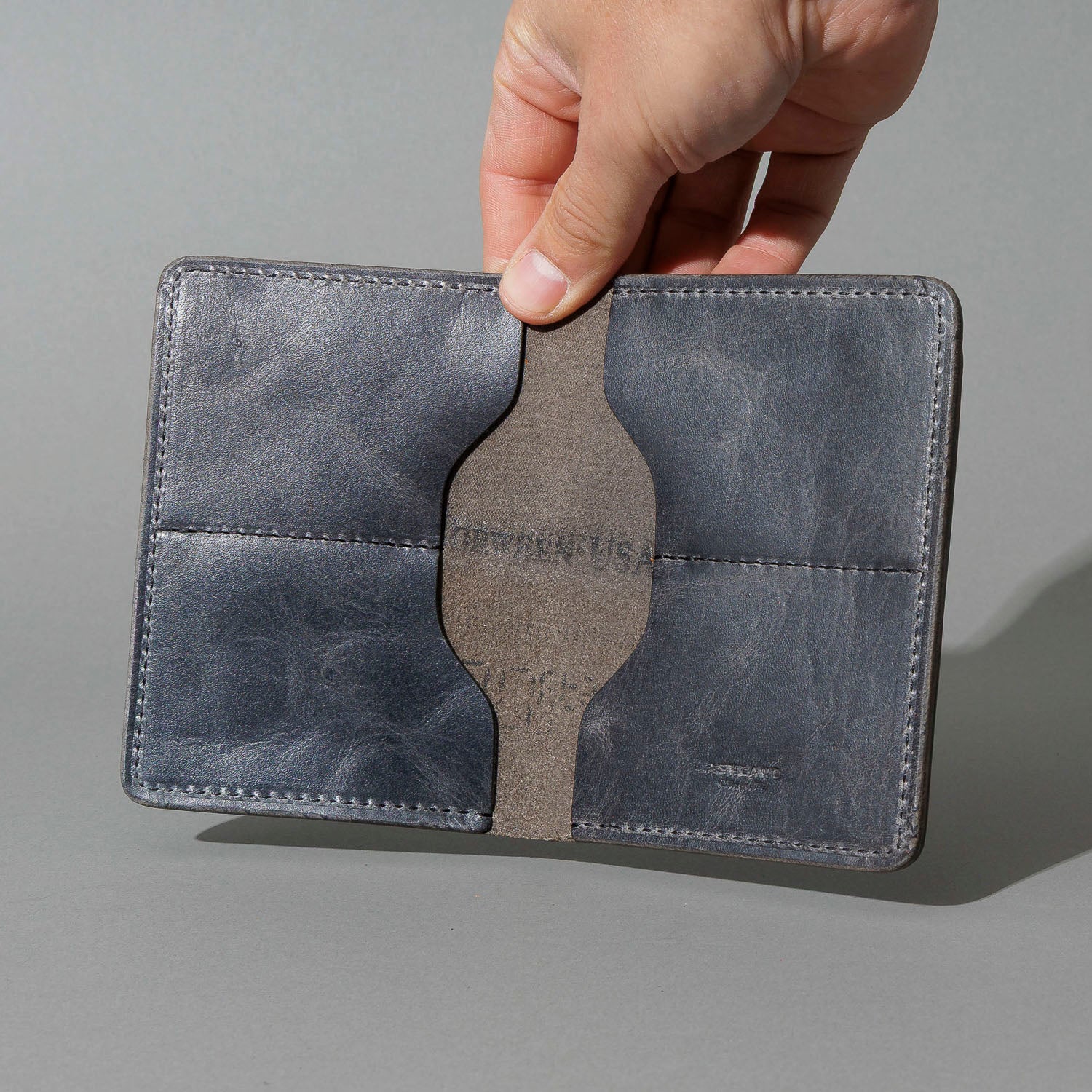 One-Off Fat Herbie in Slate Vintage, Horween® USA Stamp, held open in hand, shot 1