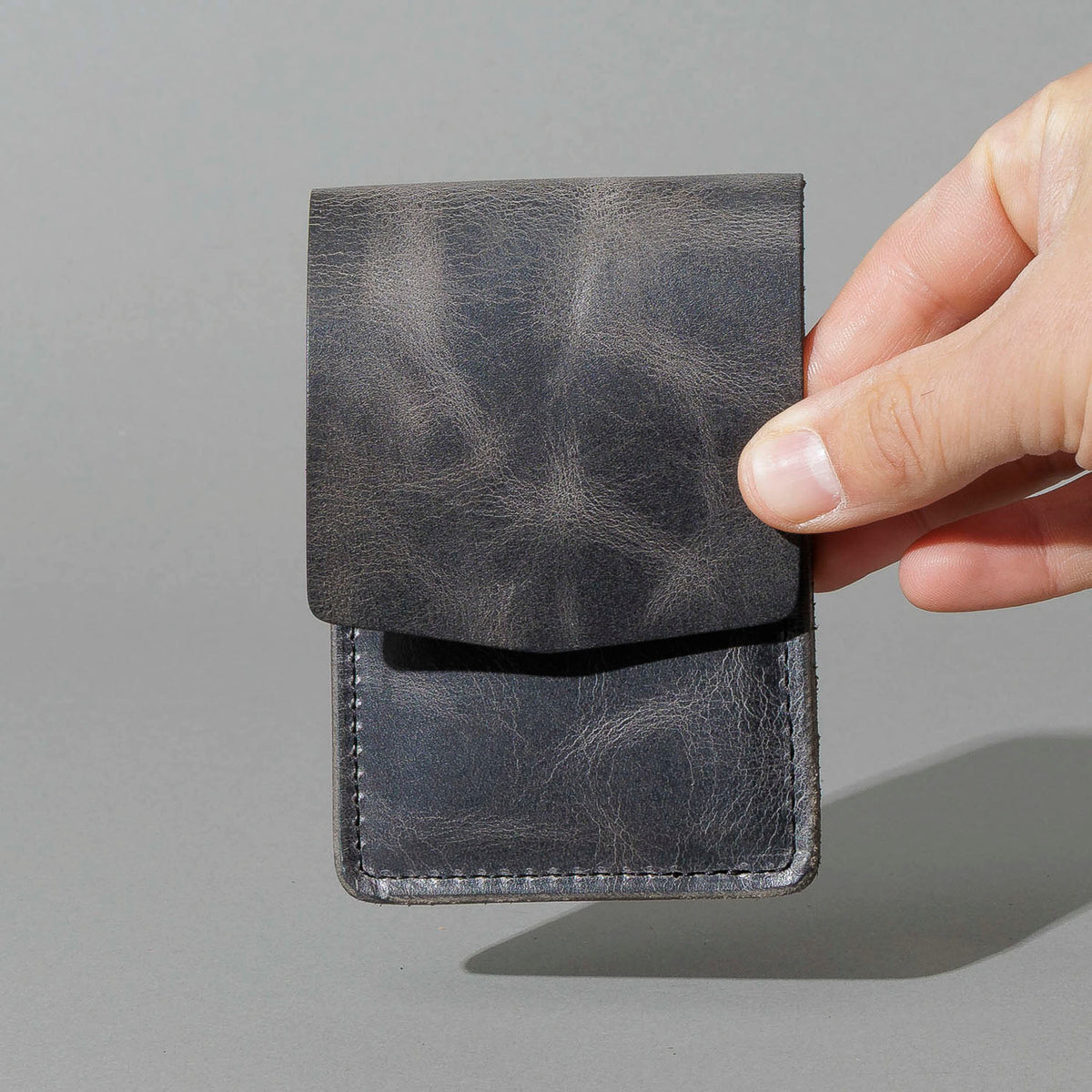 Lucky Wallet in Slate Vintage, held in hand, shot 1