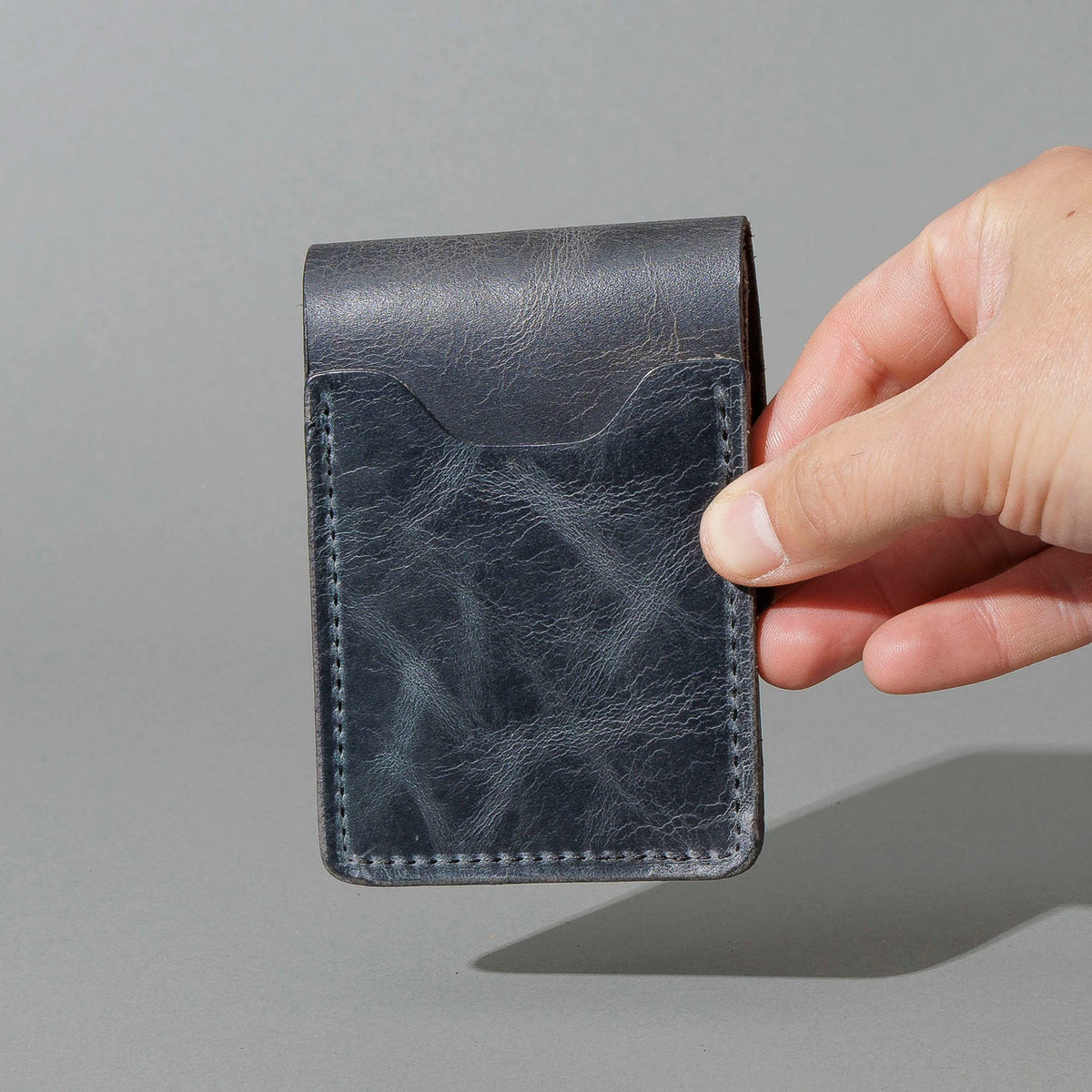 Lefty Lucky Wallet in Slate Vintage, held in hand, shot 2