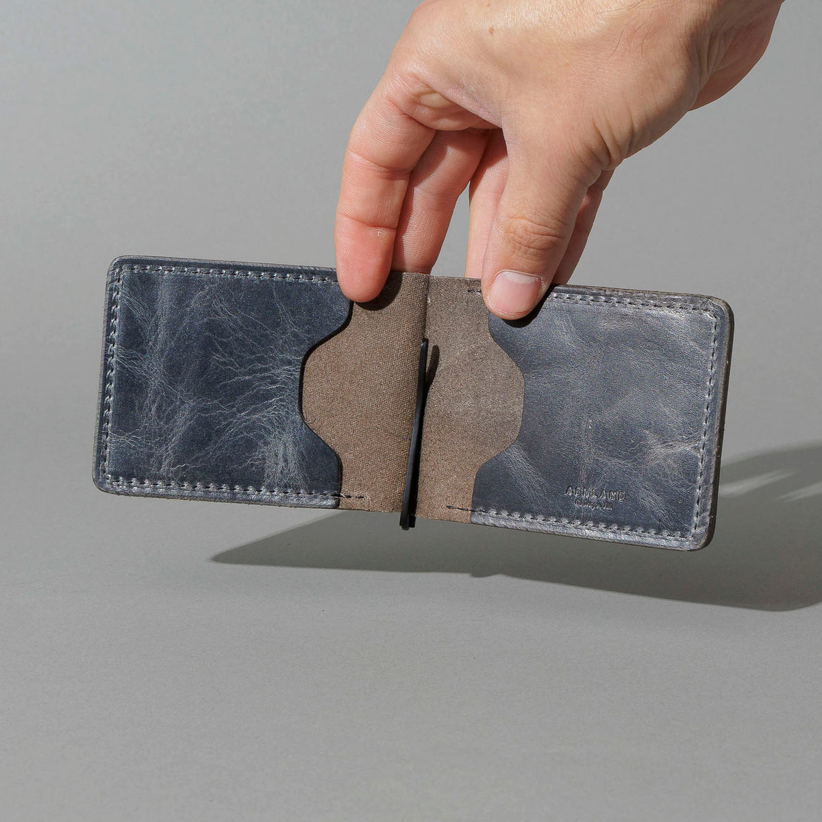 Capone Money Clip in Slate Vintage, held open in hand