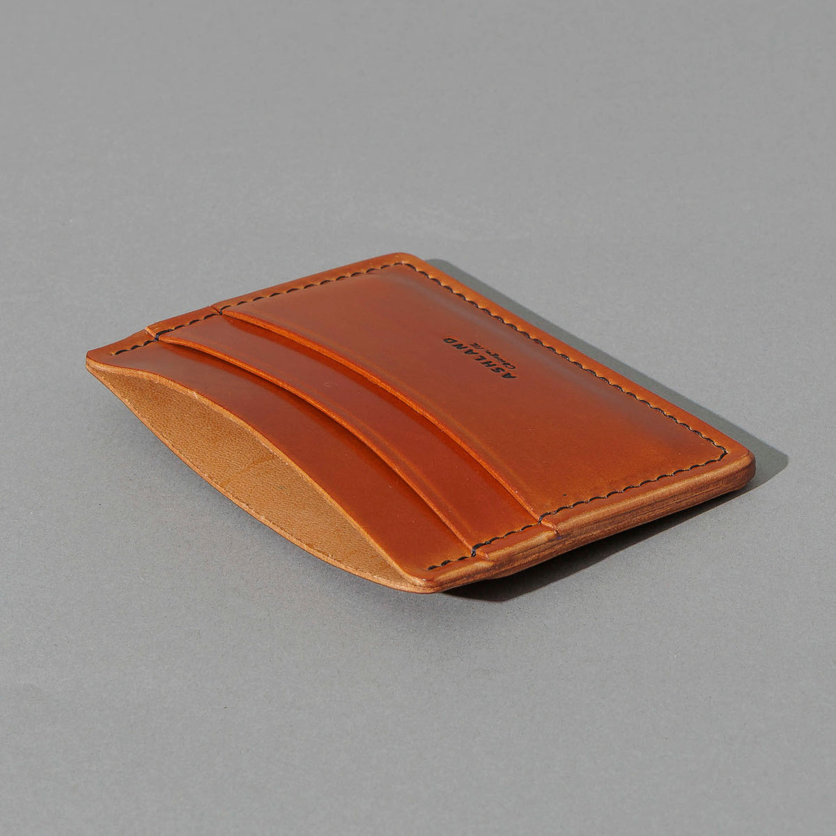 One-Off 5-Slot Frank the Enforcer in Blood Orange Shell Cordovan, angled view lying flat, shot 1