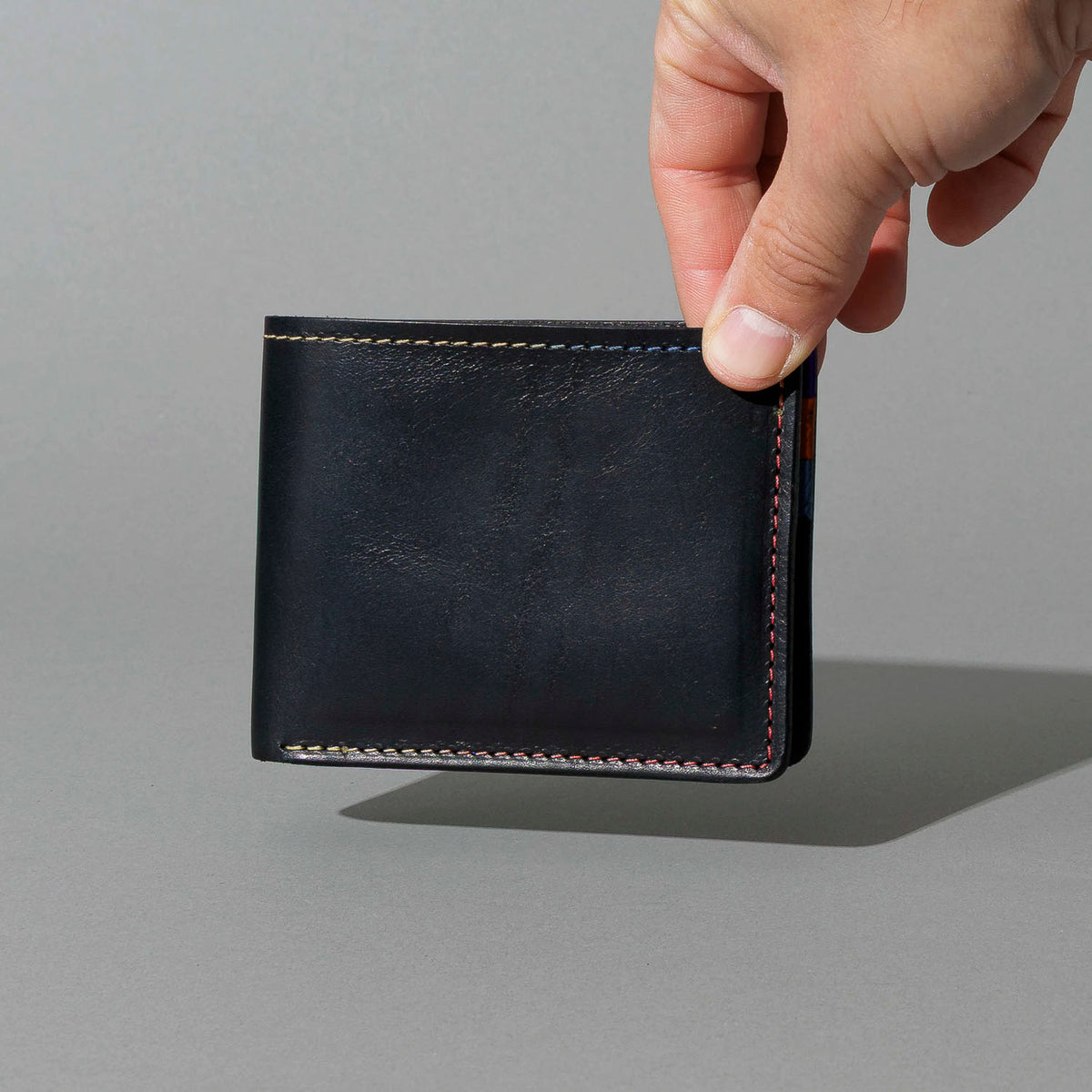 Johnny the Fox in Black Dublin with Multicolor Interior, held in hand, shot 2