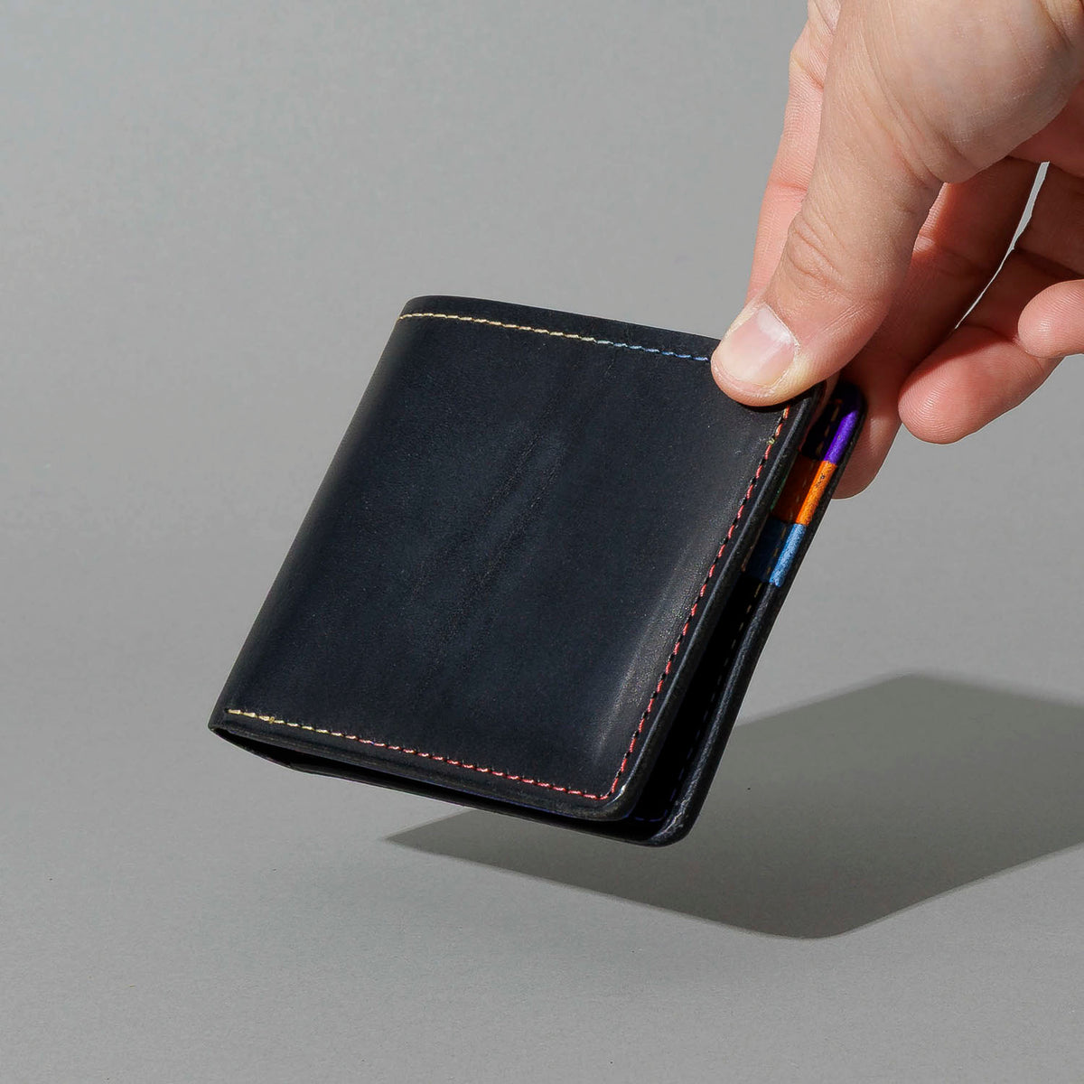Johnny the Fox in Black Dublin with Multicolor Interior, held in hand, shot 1