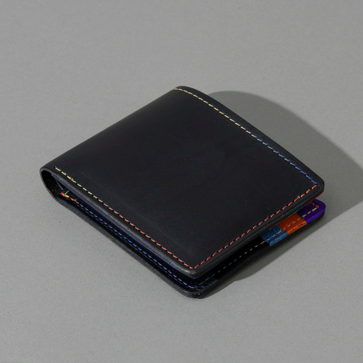 Johnny the Fox in Black Dublin with Multicolor Interior, angled view lying flat