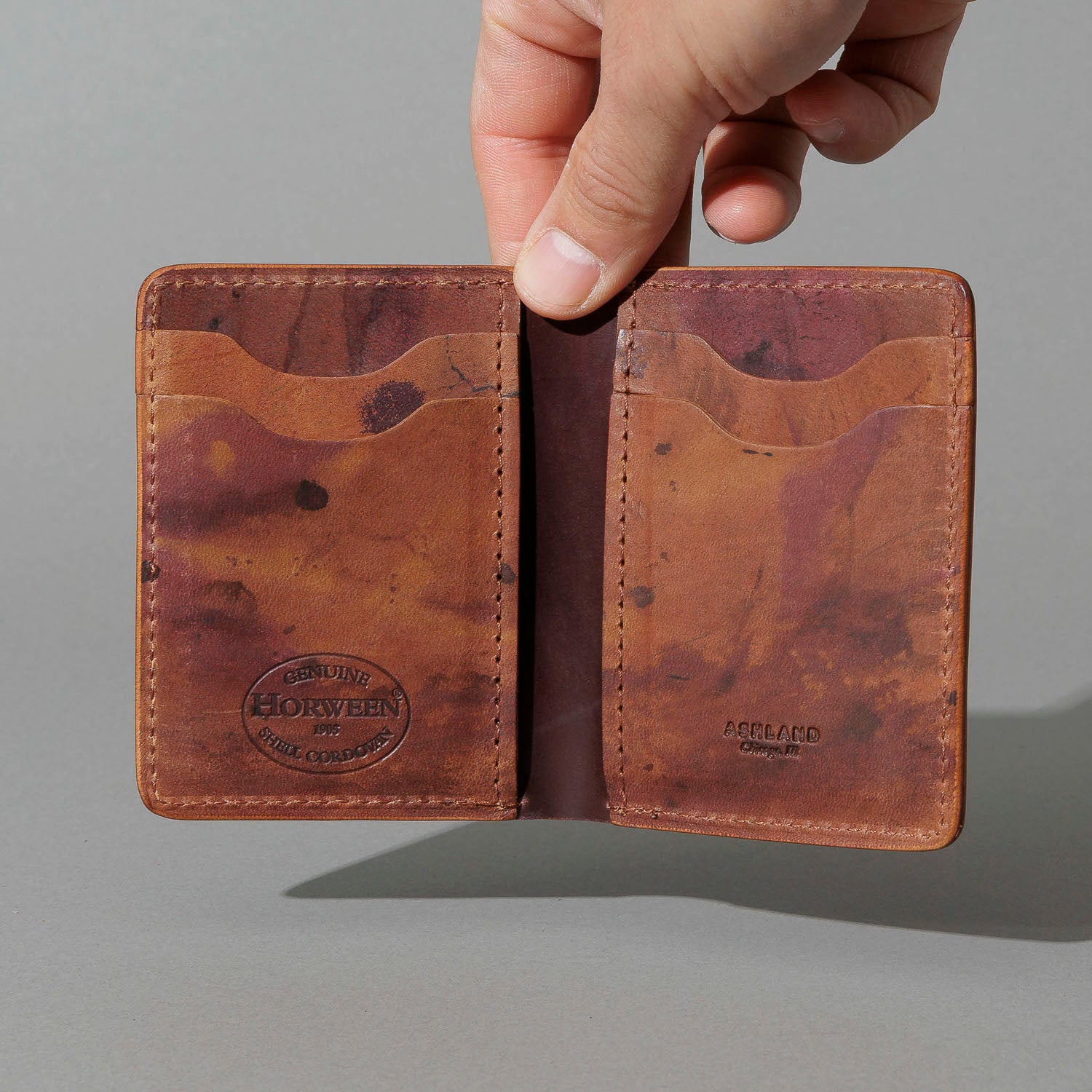 One-Off Vertical Bugs Moran in Hand-Glazed Reverse Color 8 Shell Cordovan, held open in hand, shot 1