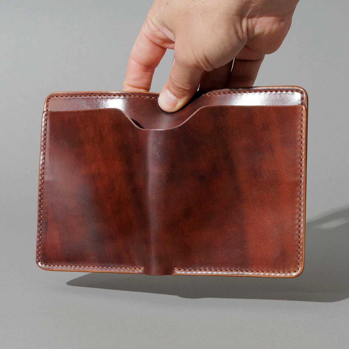 One-Off Fat Herbie in Marbled Color 8 Shell Cordovan with Reverse Interior, held open in hand, shot 1