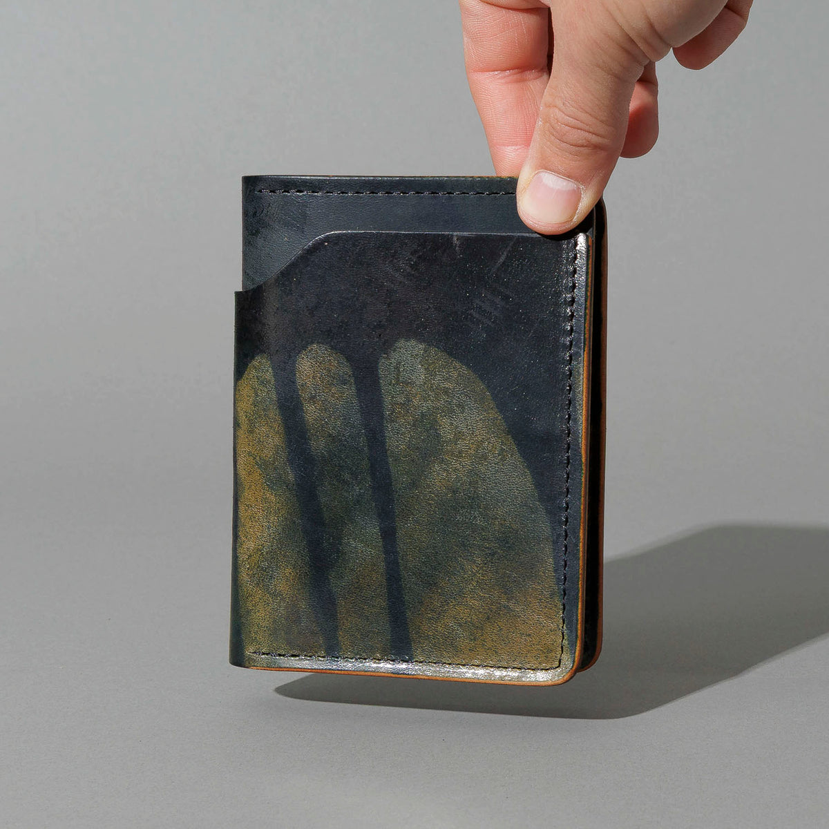 One-Off Fat Herbie in Hand-Glazed Epic Reverse Green Shell Cordovan, held in hand