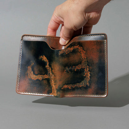 One-Off Fat Herbie in Branded Marbled Black Shell Cordovan, held open in hand, shot 1