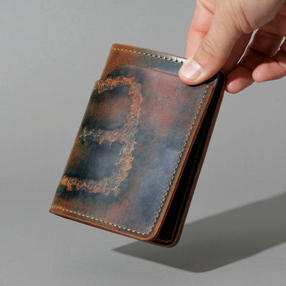 One-Off Fat Herbie in Branded Marbled Black Shell Cordovan, held open in hand, shot 2