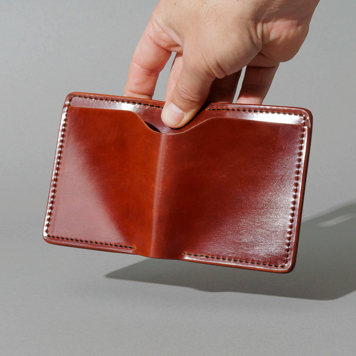 One-Off Tony the Ant in Garnet Shell Cordovan, held open in hand, shot 1