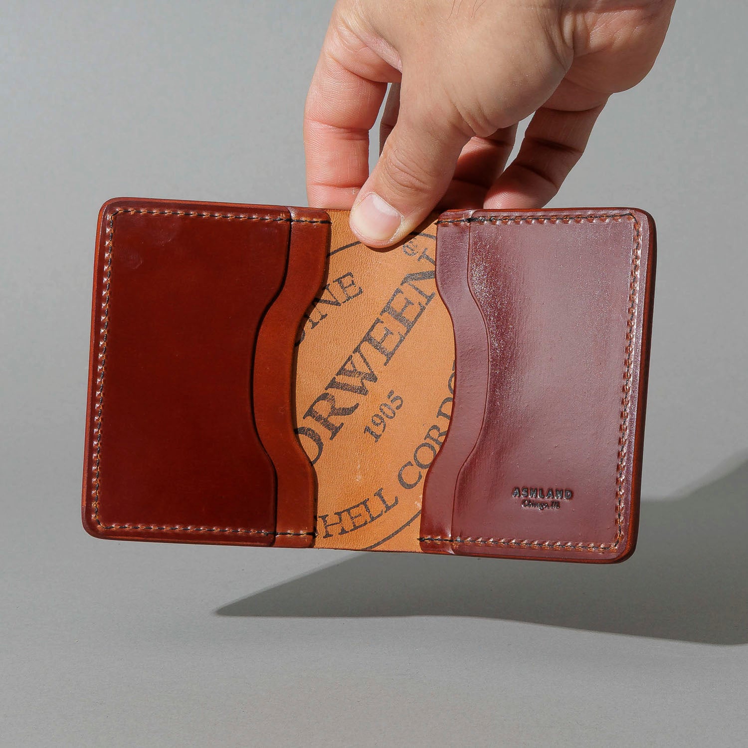 One-Off Tony the Ant in Garnet Shell Cordovan, held open in hand, shot 2