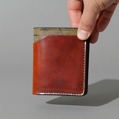 One-Off Vertical Tony the Ant in Blood Orange Shell Cordovan on Reverse Shell Cordovan, held in hand