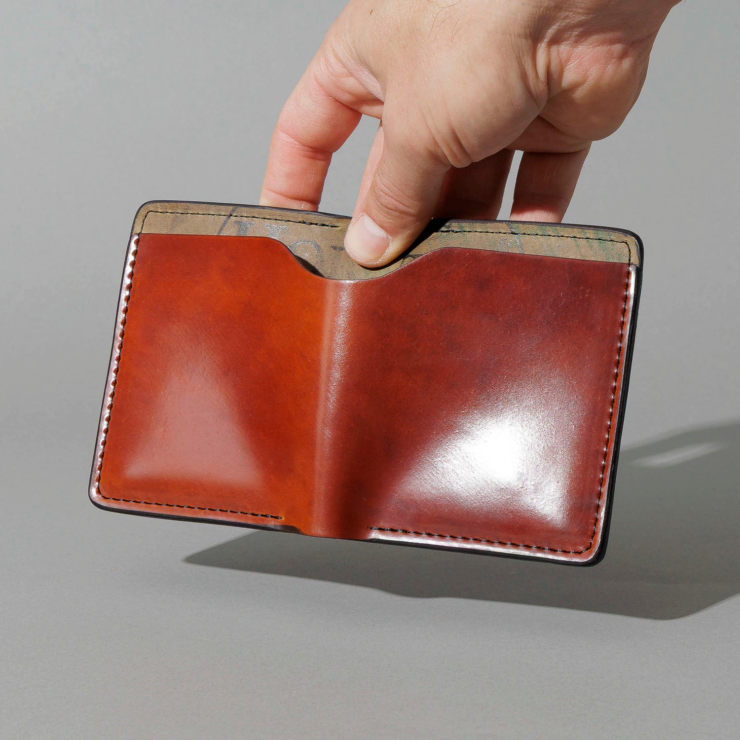 One-Off Vertical Tony the Ant in Blood Orange Shell Cordovan on Reverse Shell Cordovan, held open in hand, shot 2