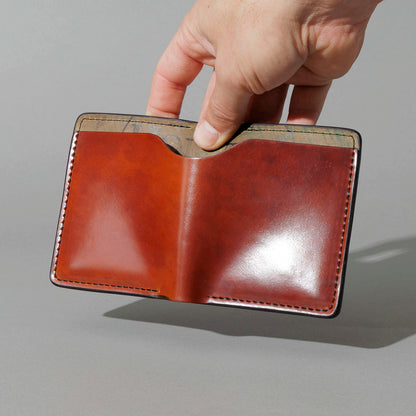 One-Off Vertical Tony the Ant in Blood Orange Shell Cordovan on Reverse Shell Cordovan, held open in hand, shot 2