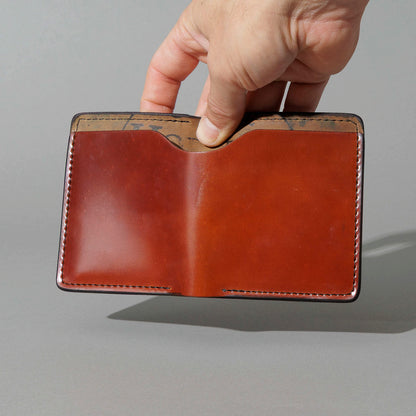 One-Off Vertical Tony the Ant in Blood Orange on Reverse Shell Cordovan, held open in hand, shot 2