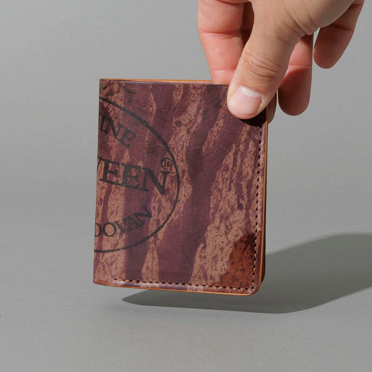 One-Off Tall Vertical Tony in Hand-Glazed Reverse Color 8 Shell Cordovan, held in hand