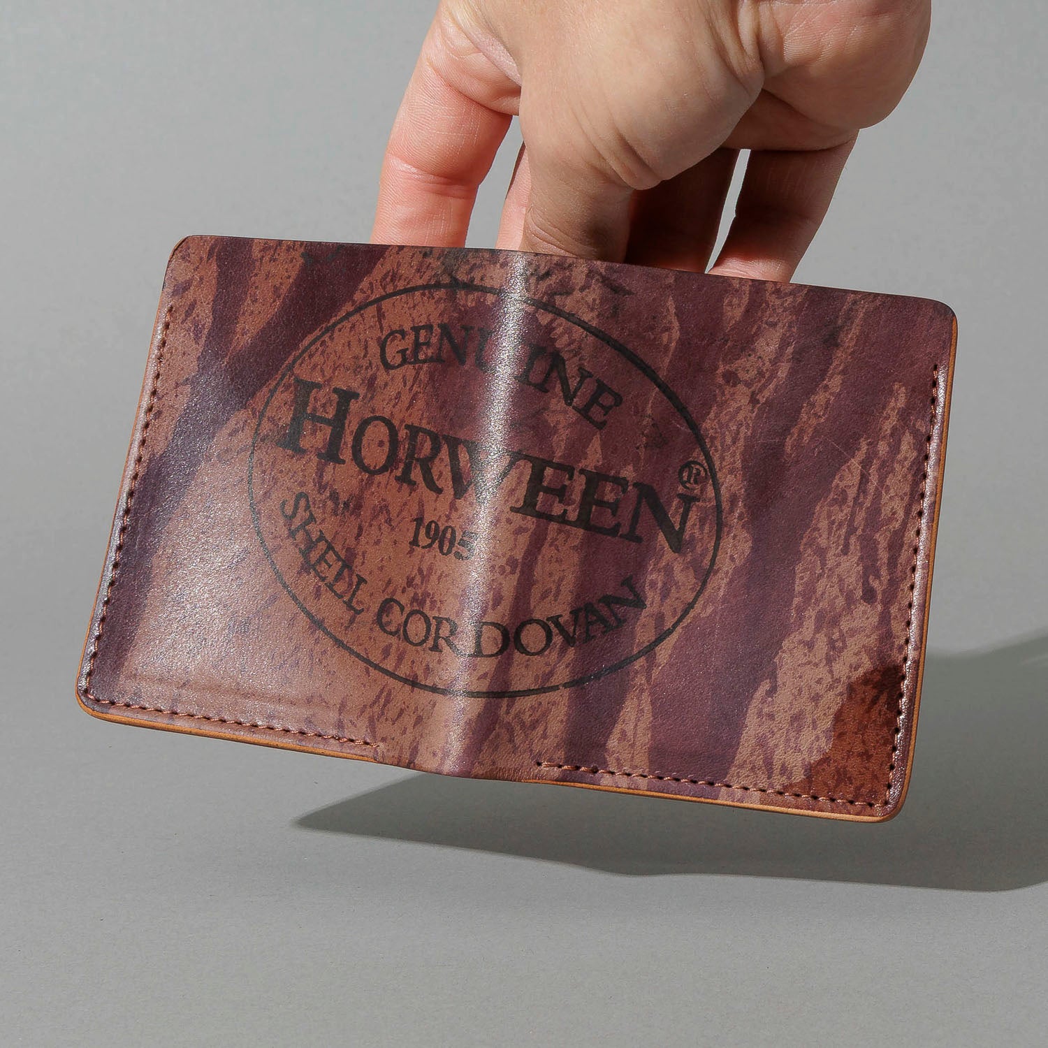 One-Off Tall Vertical Tony in Hand-Glazed Reverse Color 8 Shell Cordovan, held open in hand, shot 2